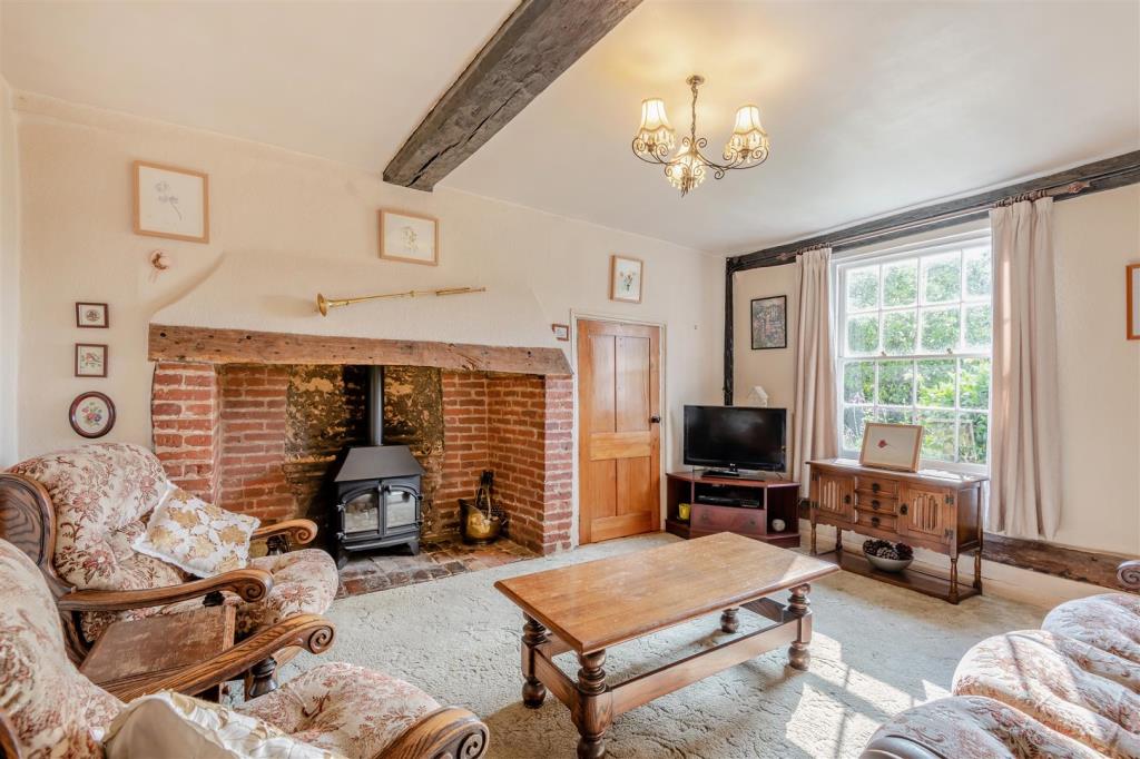 Lot: 91 - PERIOD COTTAGE FOR IMPROVEMENT - Living room with inglenook fireplace
